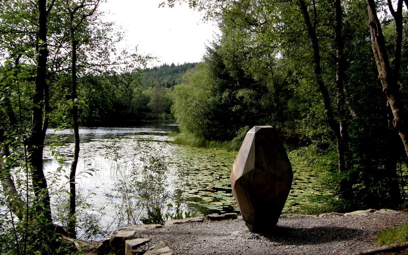 Sculpture by a lily pond