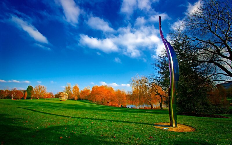 Sculpture in a park with autumn trees