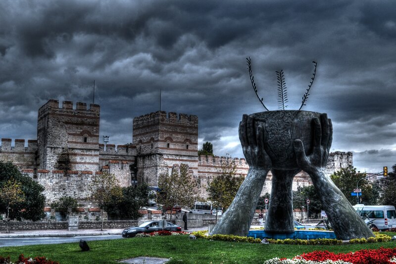 Sculpture in front of ancient walls