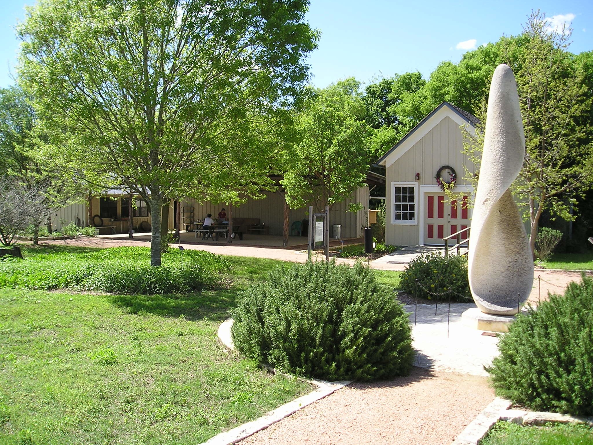 Sculpture in garden with building