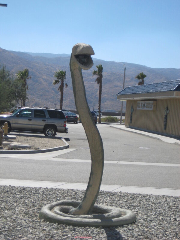 Sculpture of a cobra in a parking lot