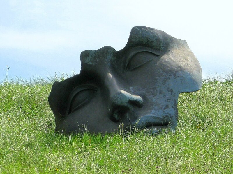 Sculpture of a face in grass