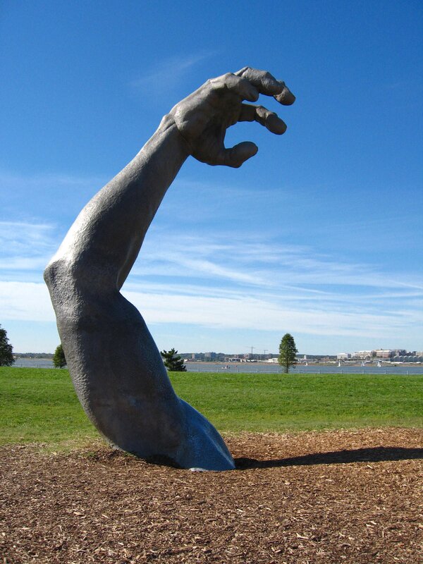 Sculpture of a hand emerging from ground