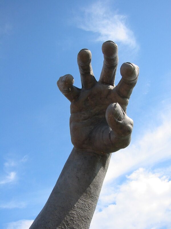 Sculpture of a reaching hand