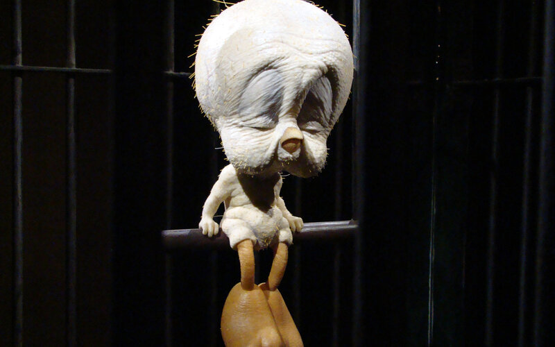 sculpture of bird in cage