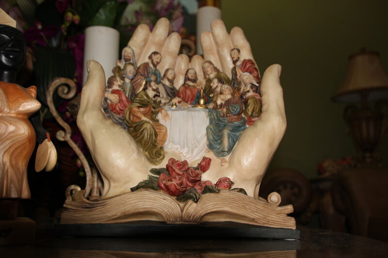 Sculpture of Hands Holding Figures