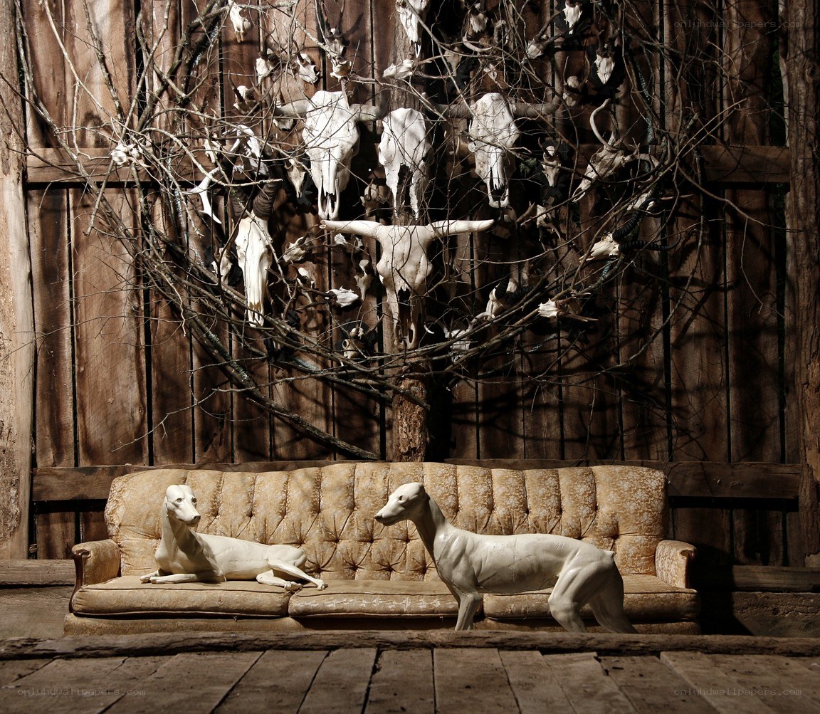 Sculptures on a sofa with skulls