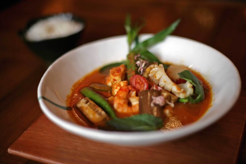 Seafood curry in a white bowl