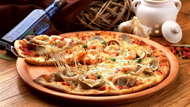 Seafood pizza on wooden plate