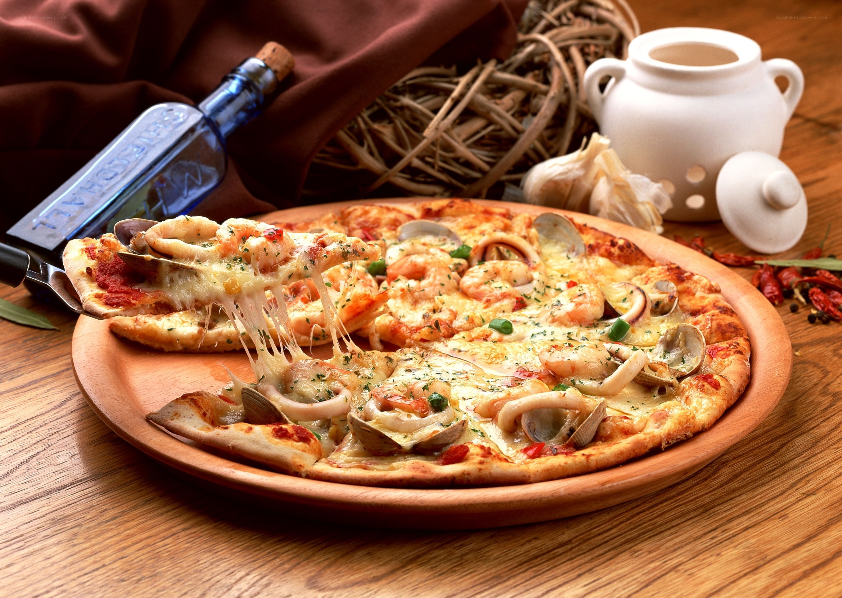 Seafood pizza on wooden platter