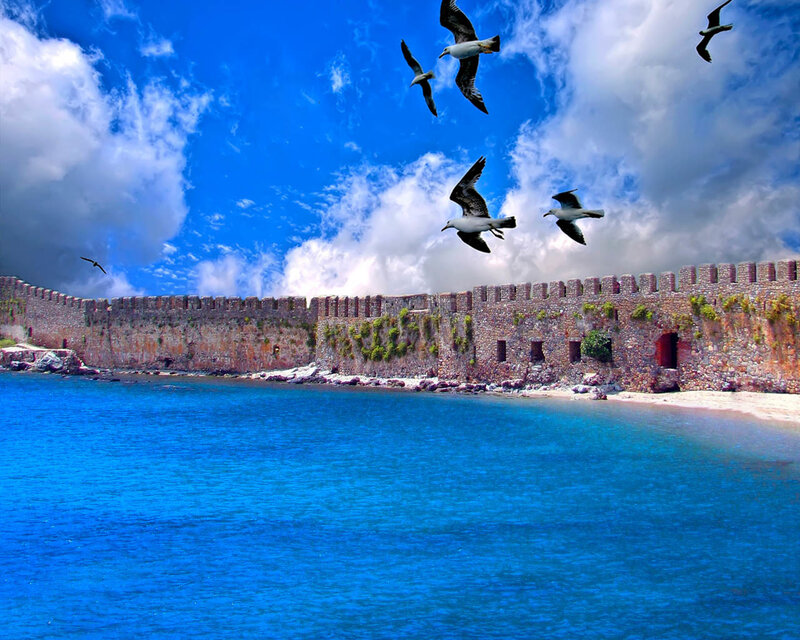 Seagulls flying over ancient fortress
