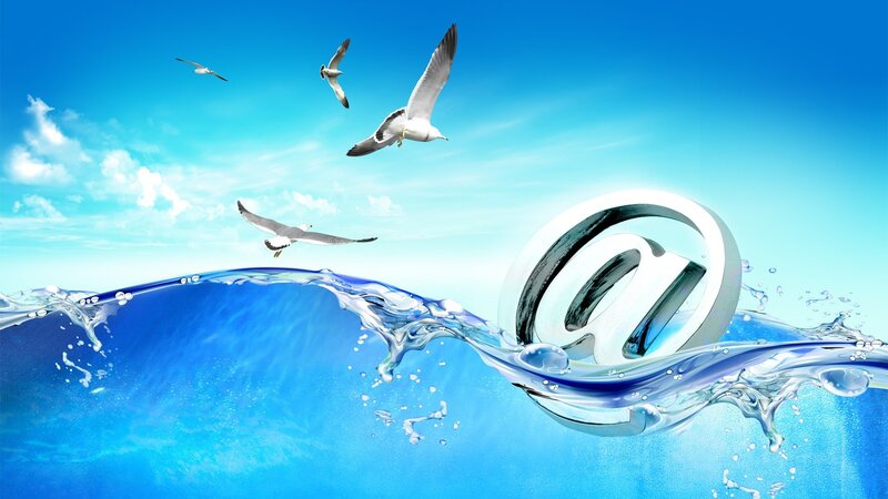 seagulls flying over water with at symbol
