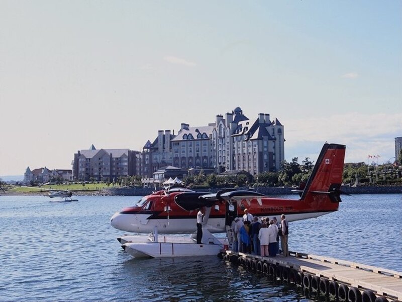 Seaplane at dock with hotel in background