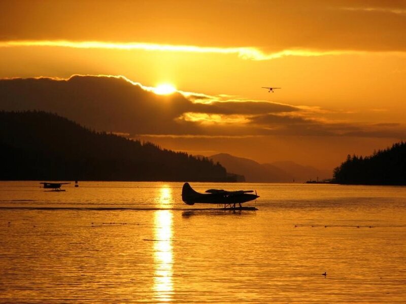 seaplane at sunset over water