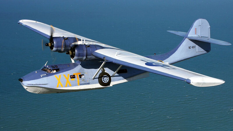 Seaplane flying over ocean