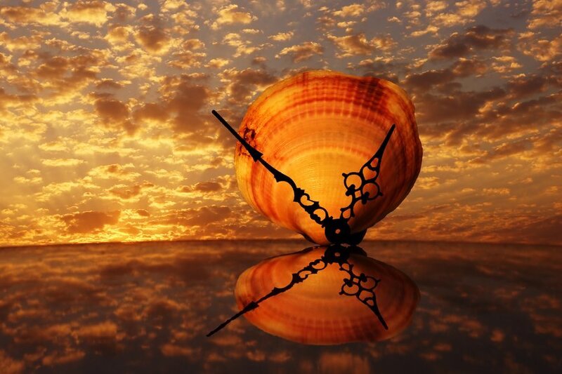 Seashell clock at sunset