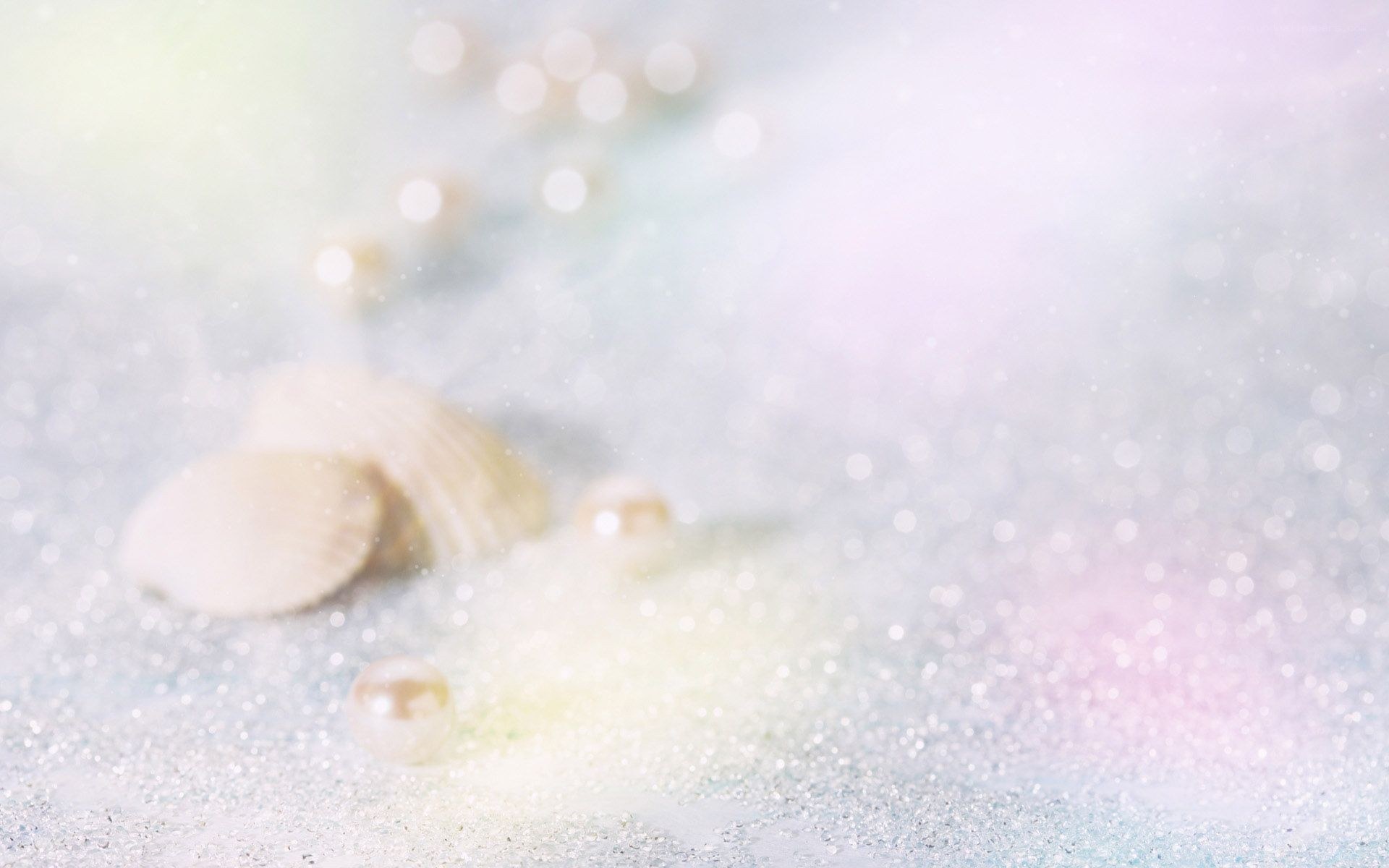 seashells and pearls on sand