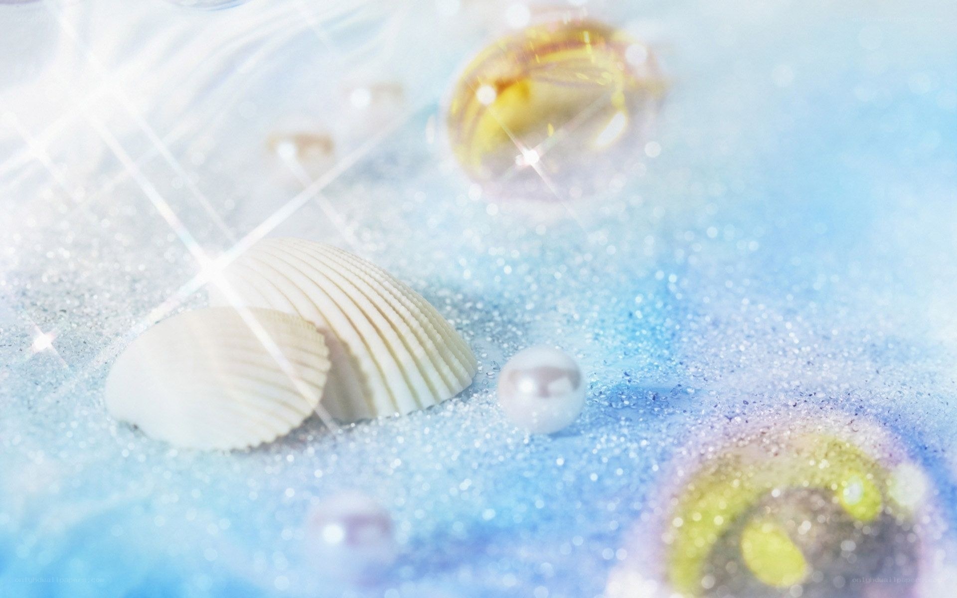 Seashells and pearls on sand