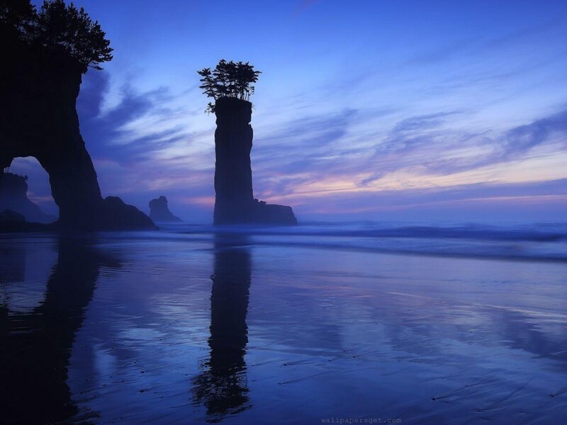 Seastack at dusk with reflection