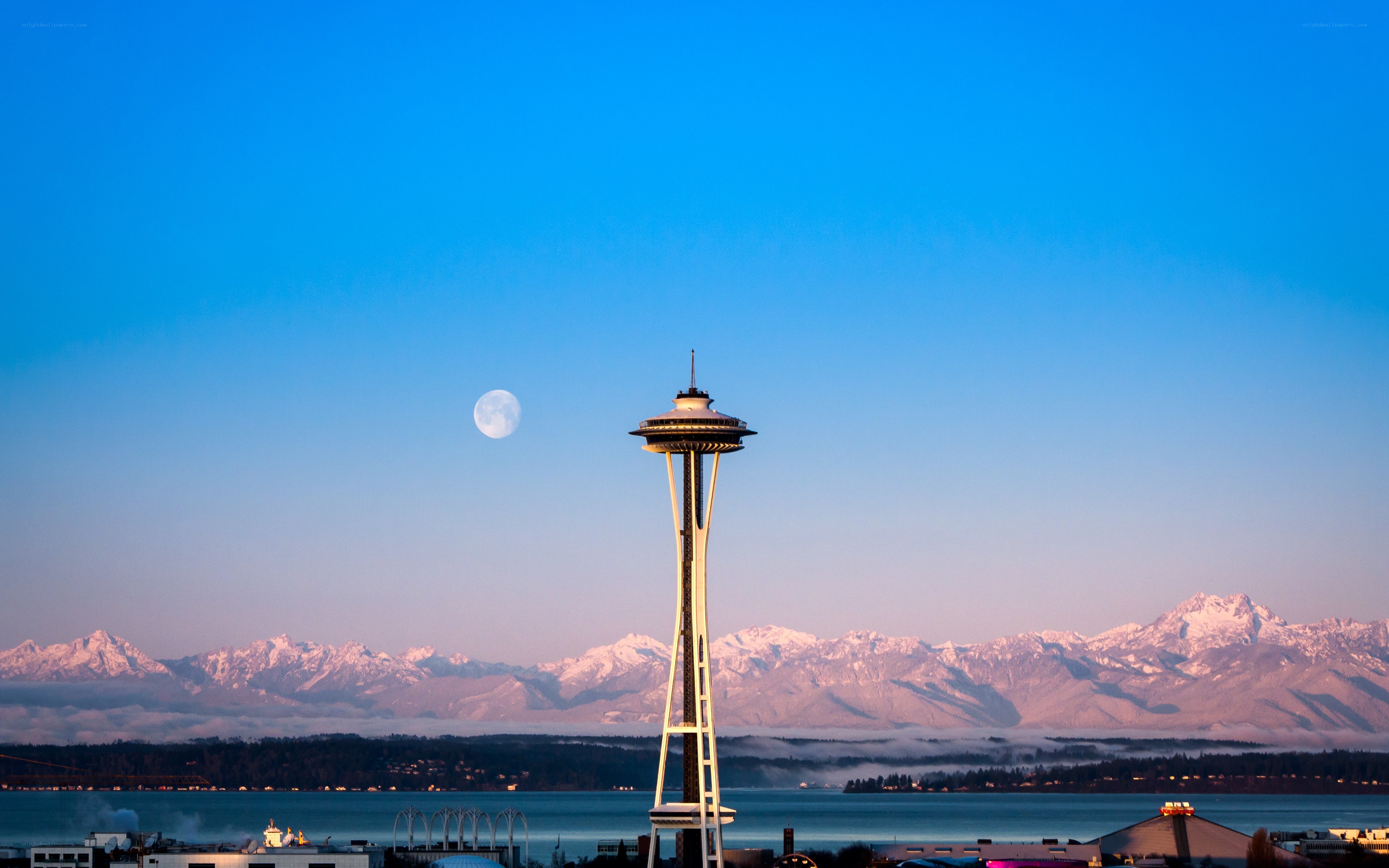 Seattle skyline with moon and mountains