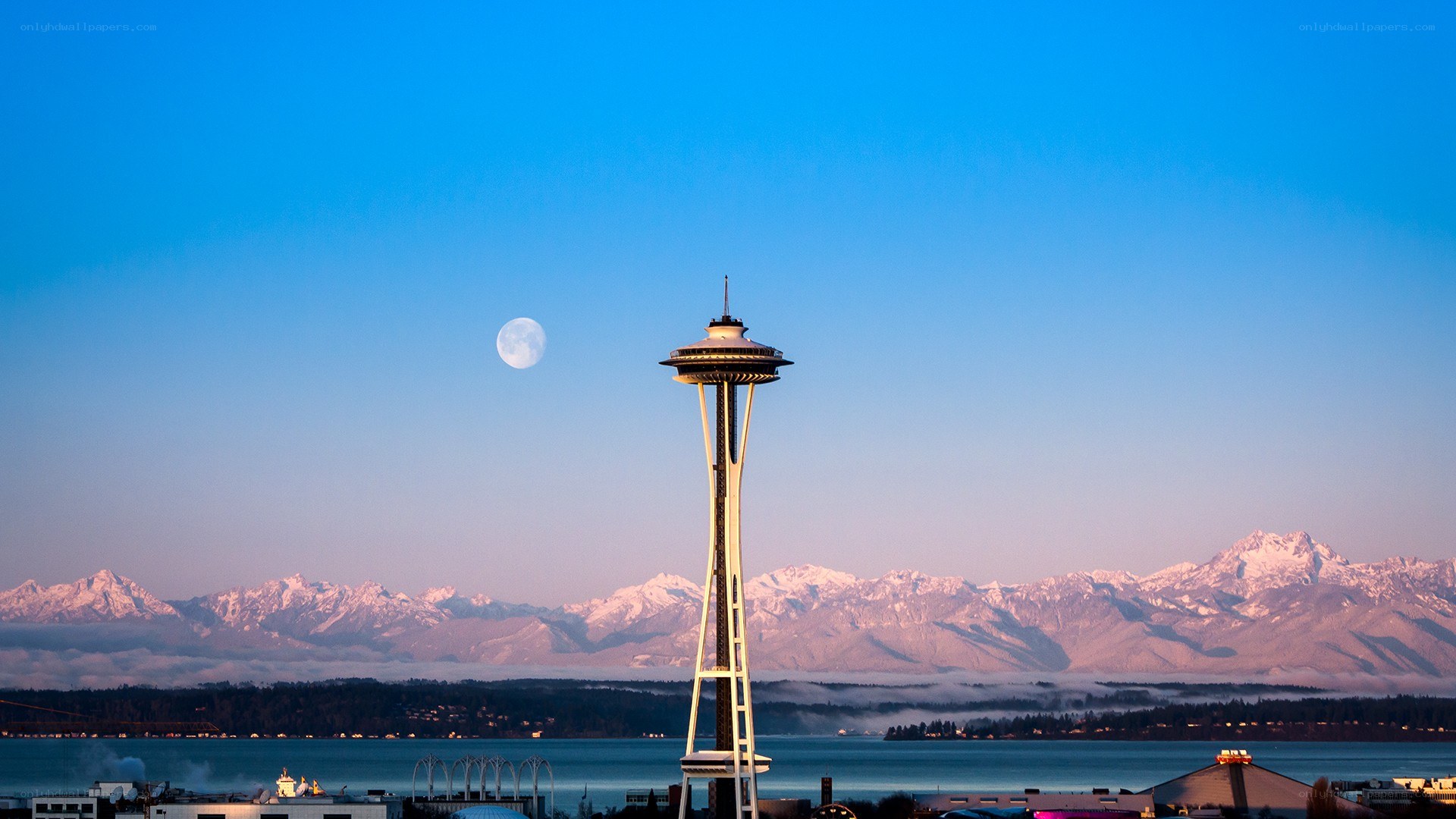 Seattle Space Needle with moon and mountains