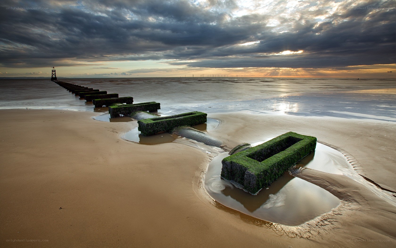 Seawall at sunset on a cloudy day