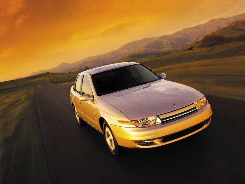 Sedan car on road at sunset