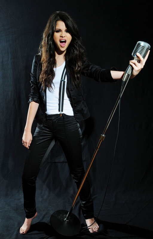 Selena Gomez singing into a microphone