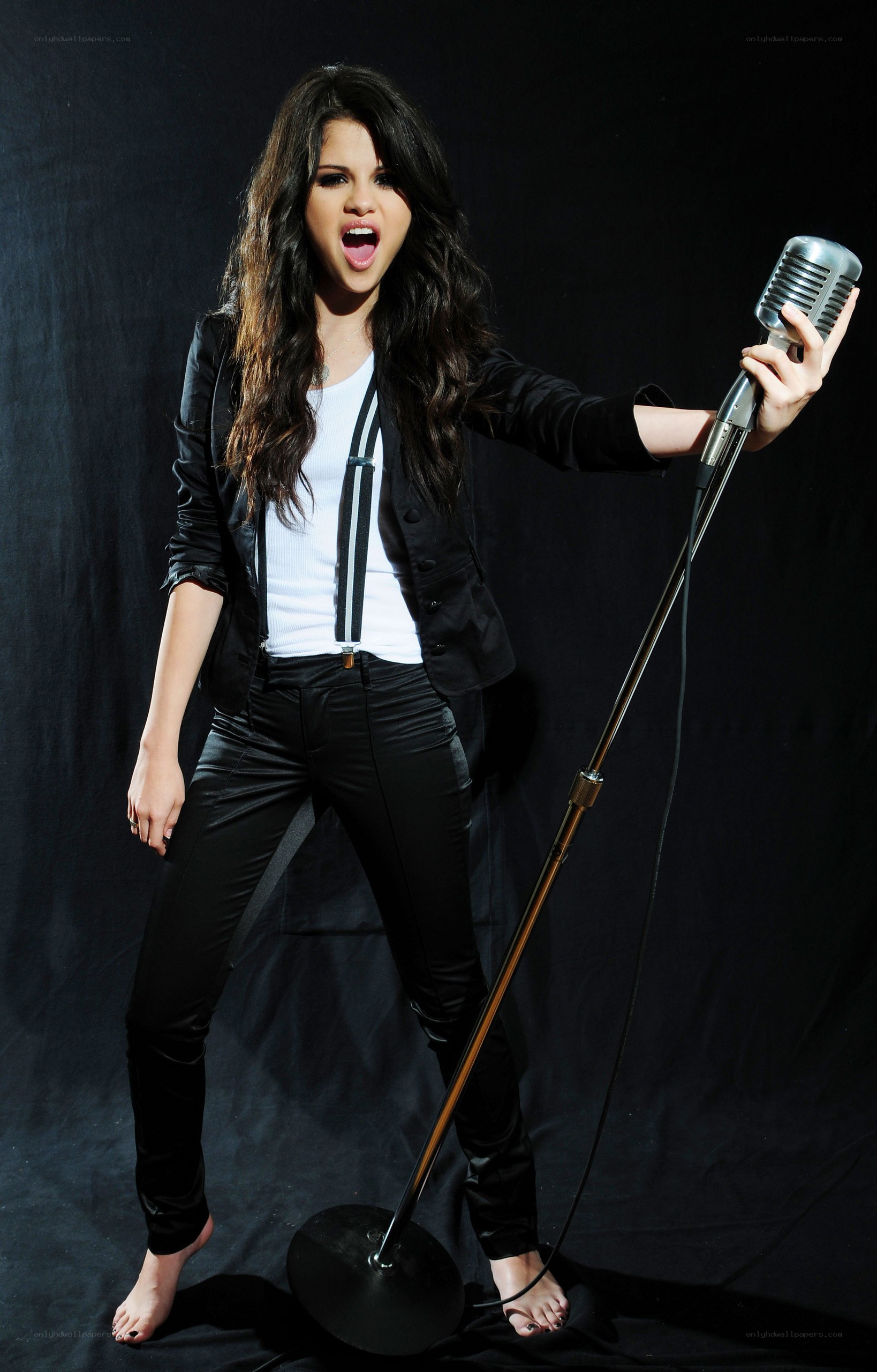Selena Gomez singing into a microphone