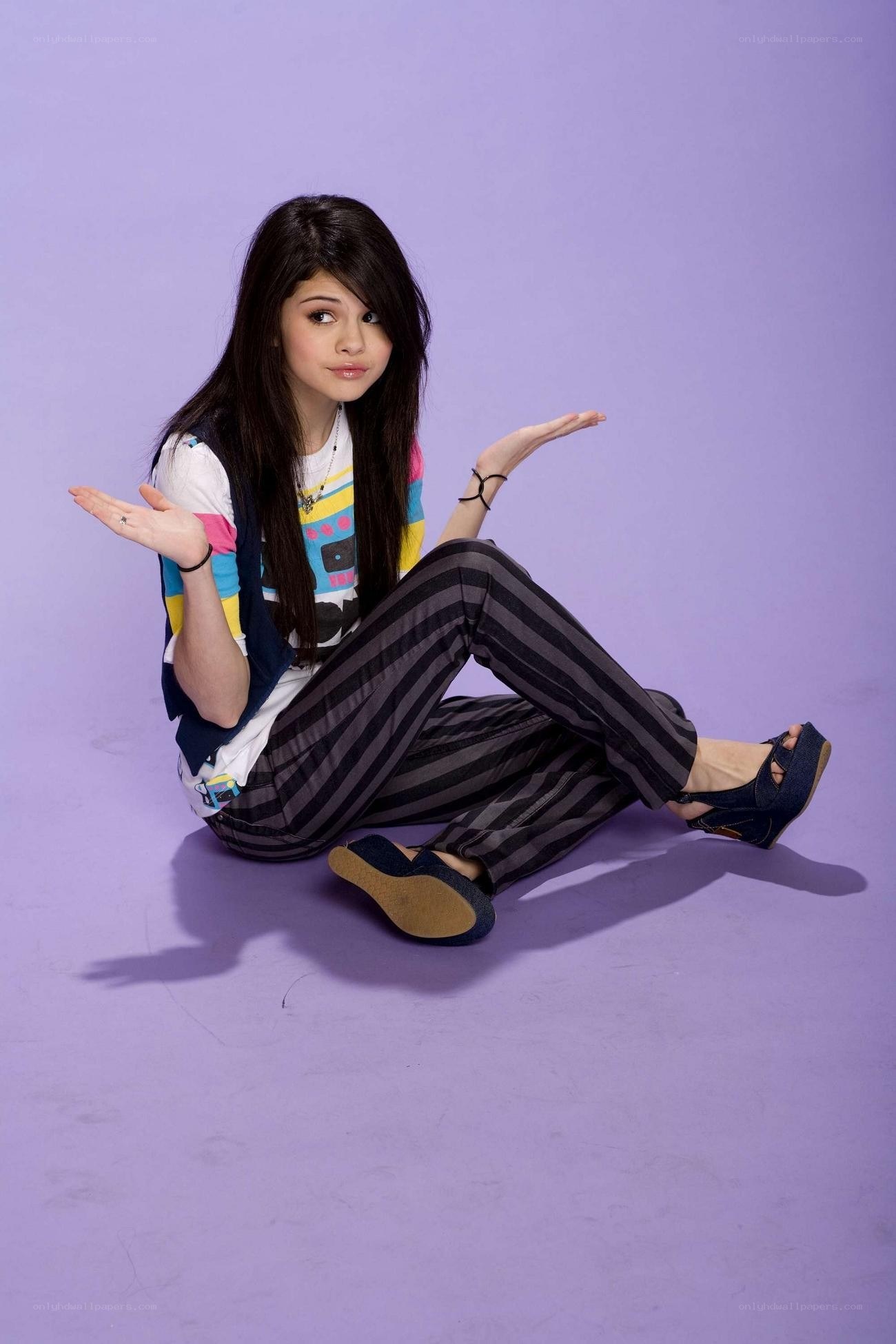Selena Gomez sitting on floor
