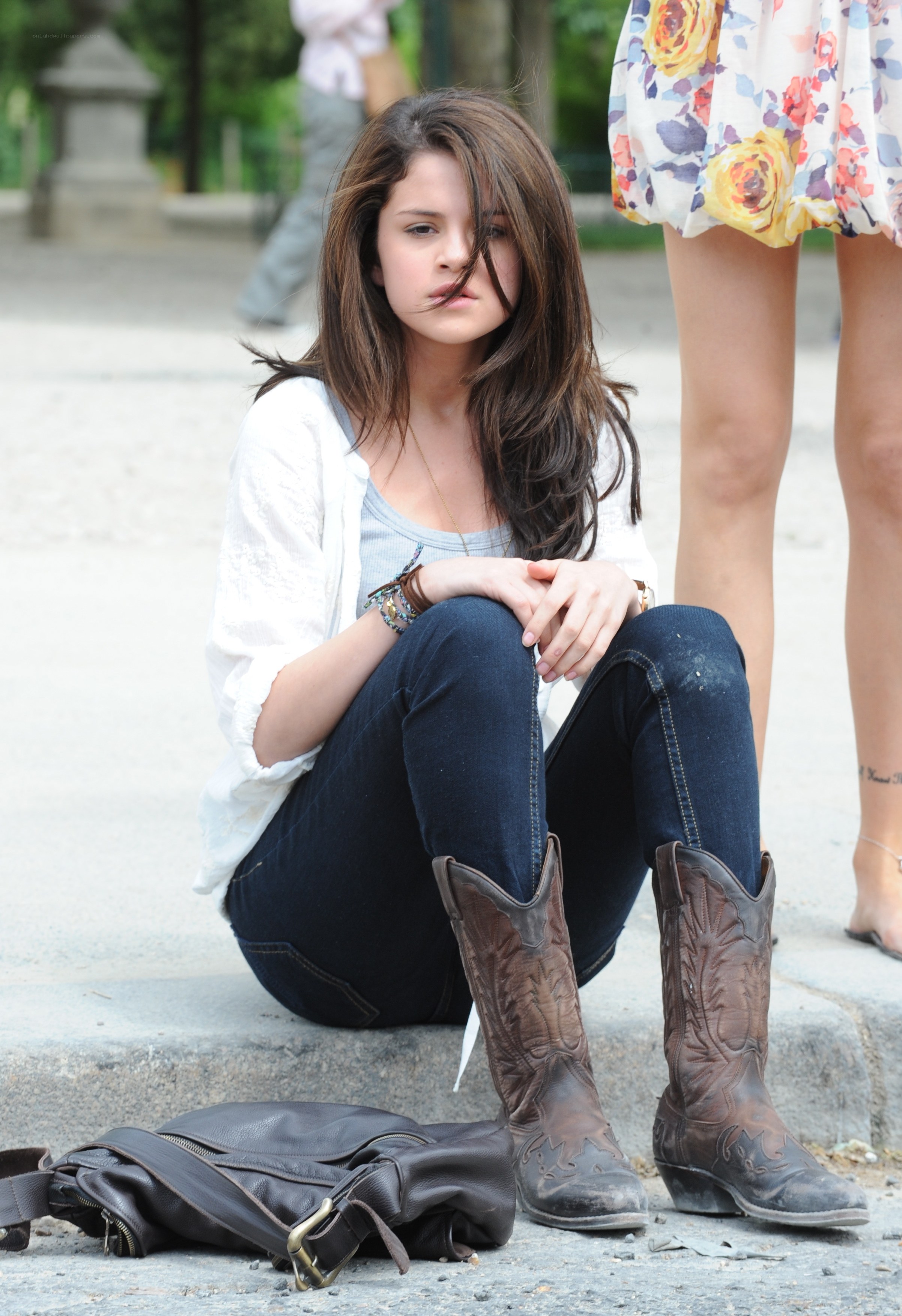 Selena Gomez sitting on steps