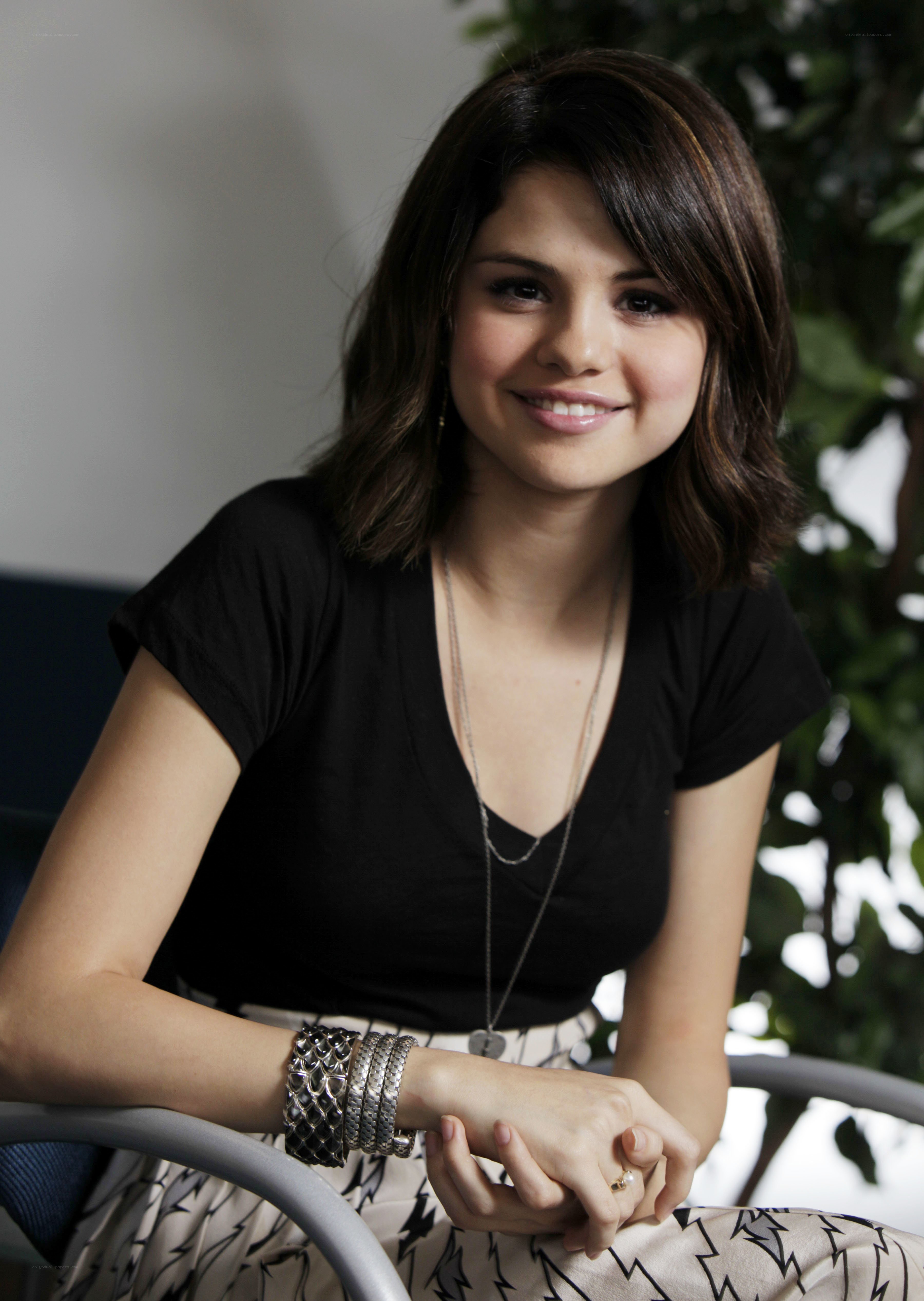 Selena Gomez smiling in black top