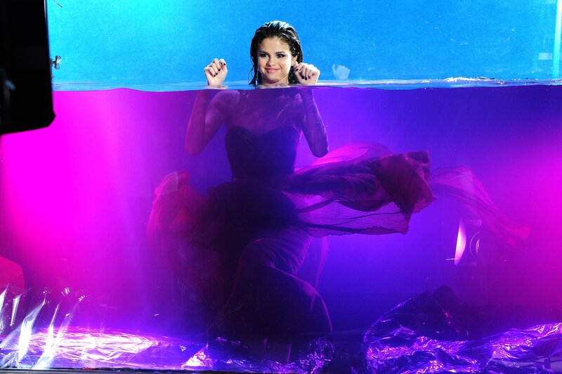 Selena Gomez underwater in a dress