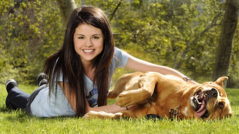 Selena Gomez with dog on grass