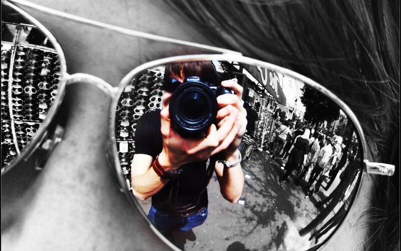 Self-portrait in sunglasses mirror