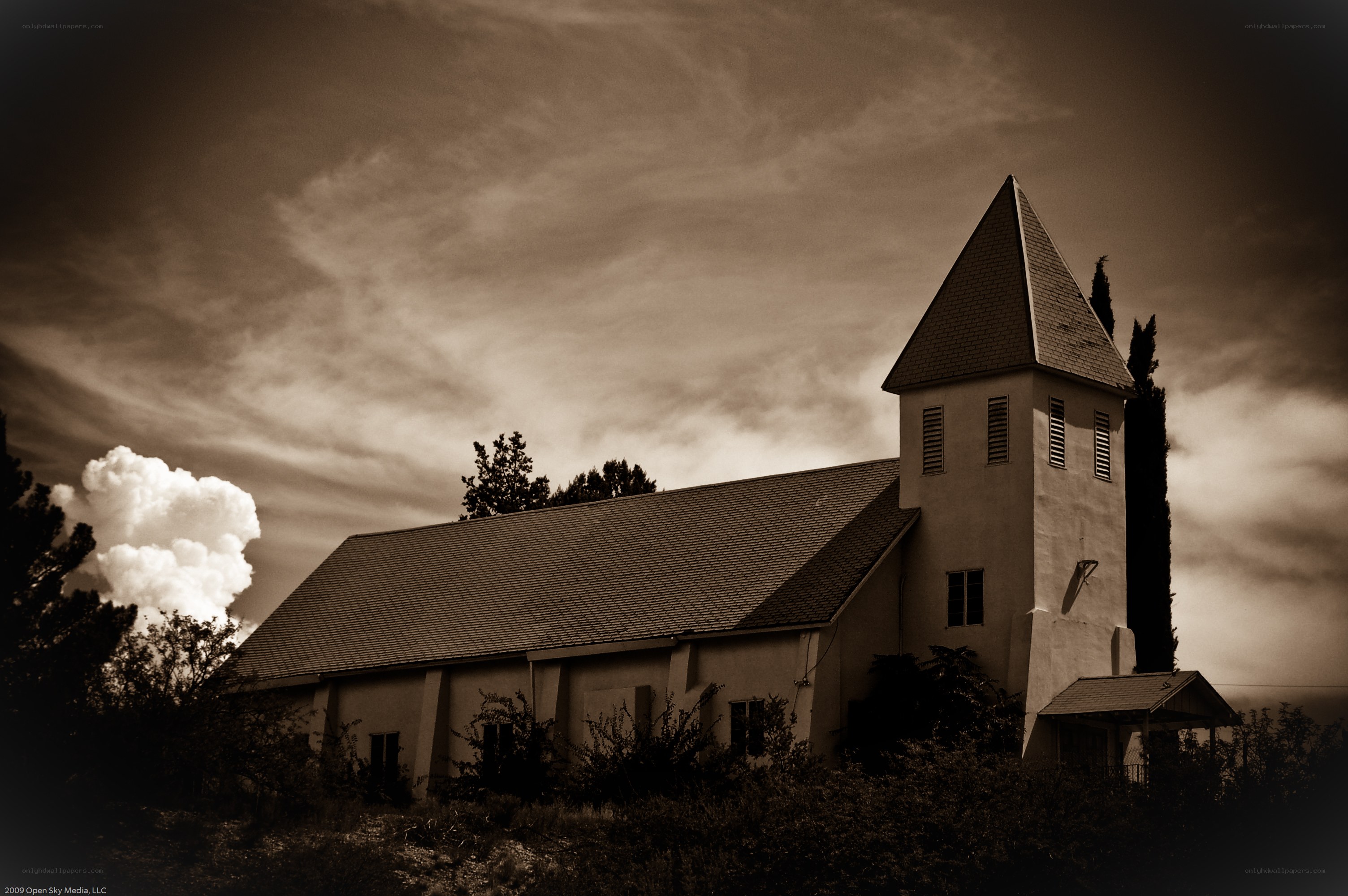 Sepia church under cloudy sky