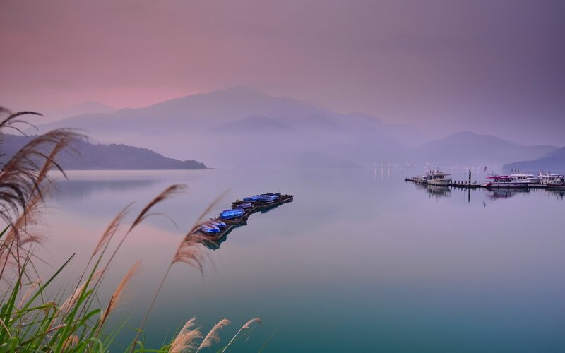 Serene lake at dawn with mountains