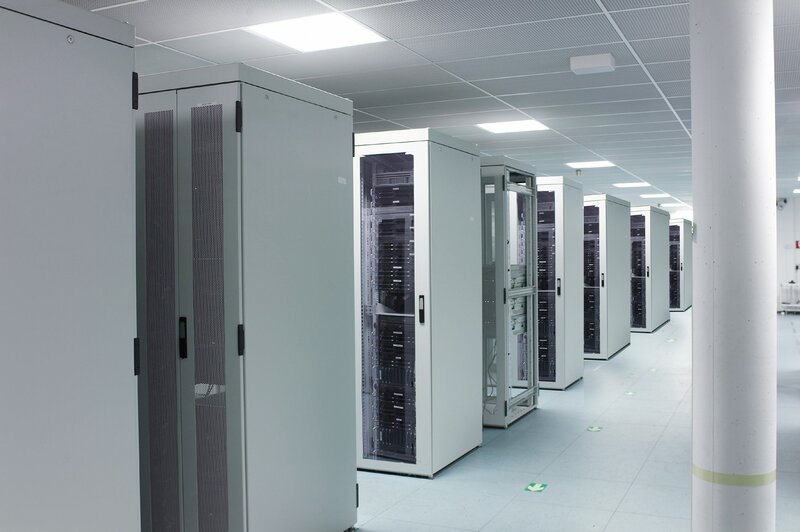 Server Racks in Data Center — White, Neutral, Photograph, Ceiling Lights, Floor, Pillar