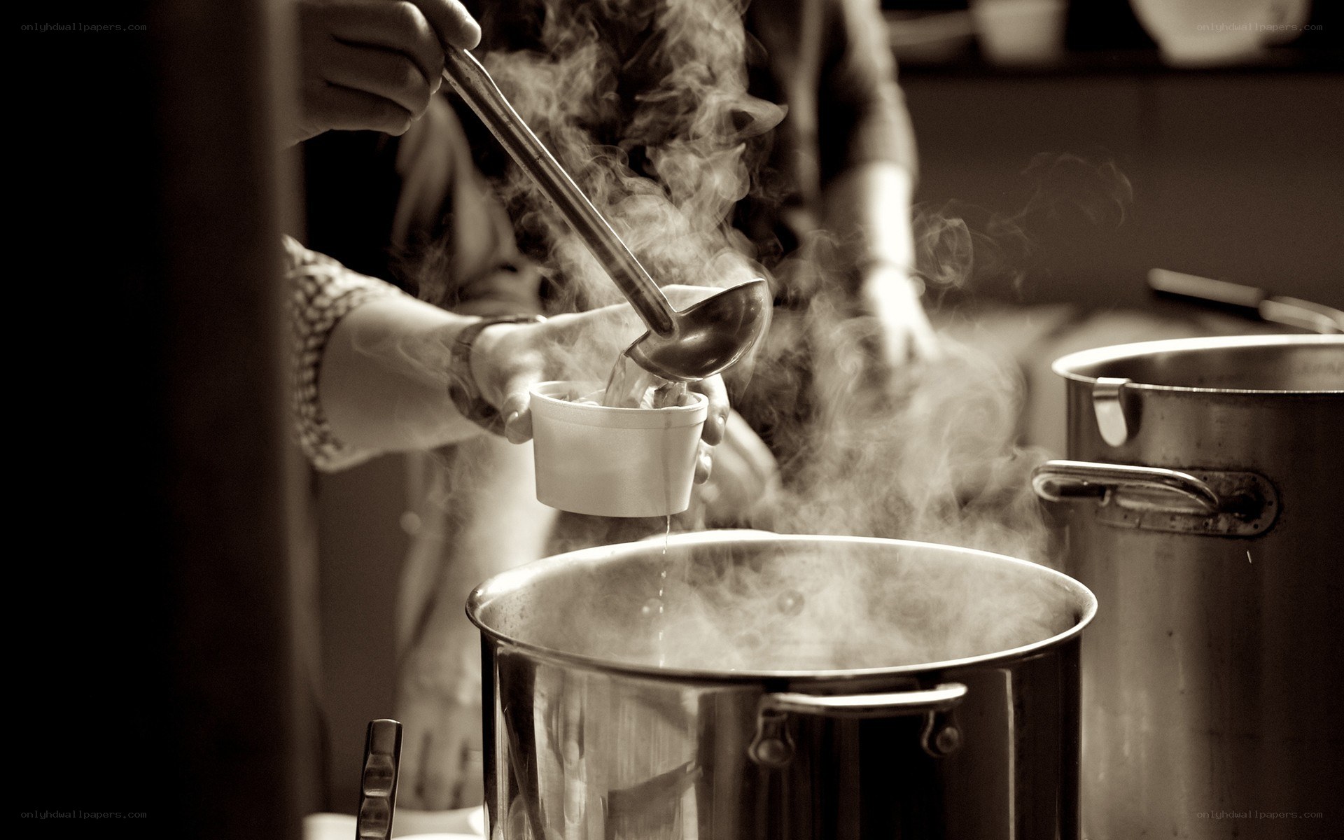 Serving steaming soup from a large pot
