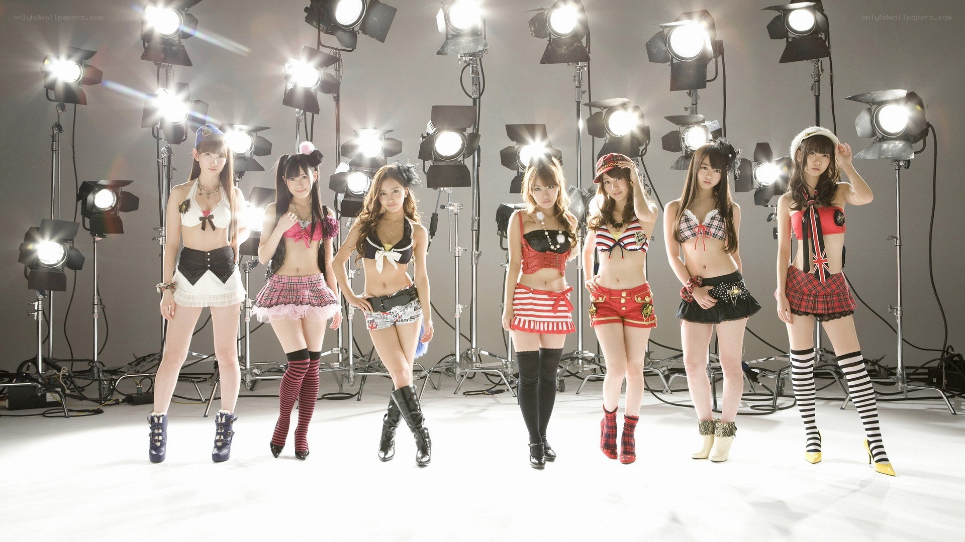 Seven female performers in a studio