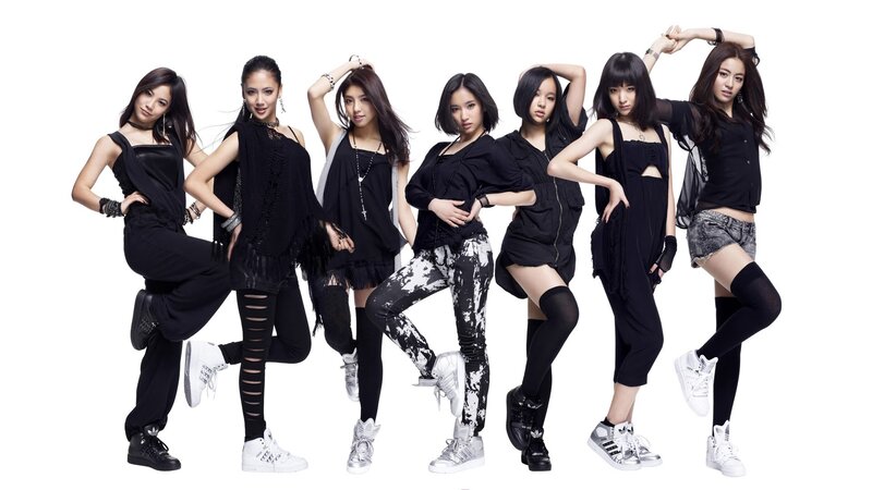 seven women in black outfits