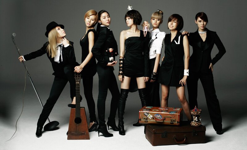 Seven Women in Black Outfits — Confident, Photograph, Microphone Stand