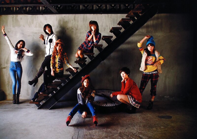 Seven women posing on stairs