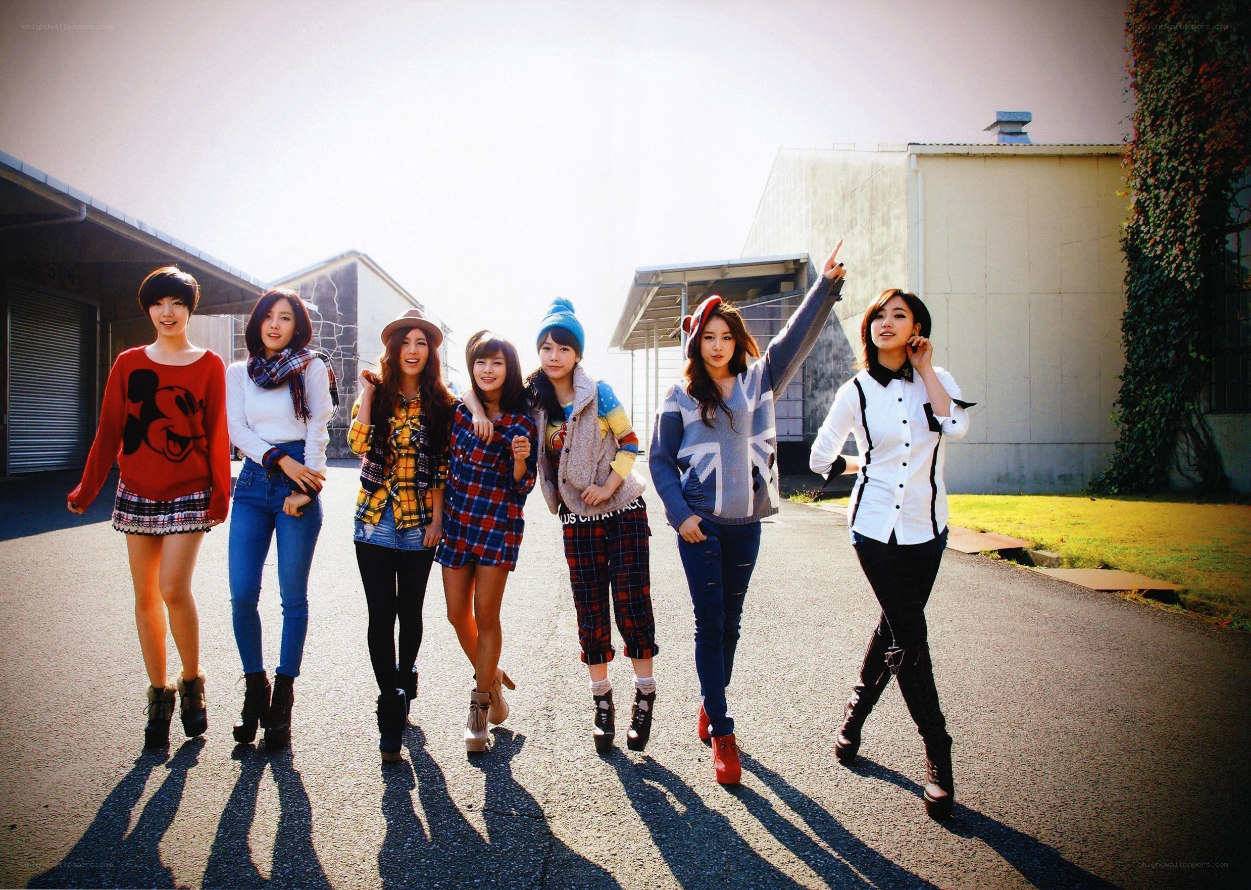 seven women posing outdoors