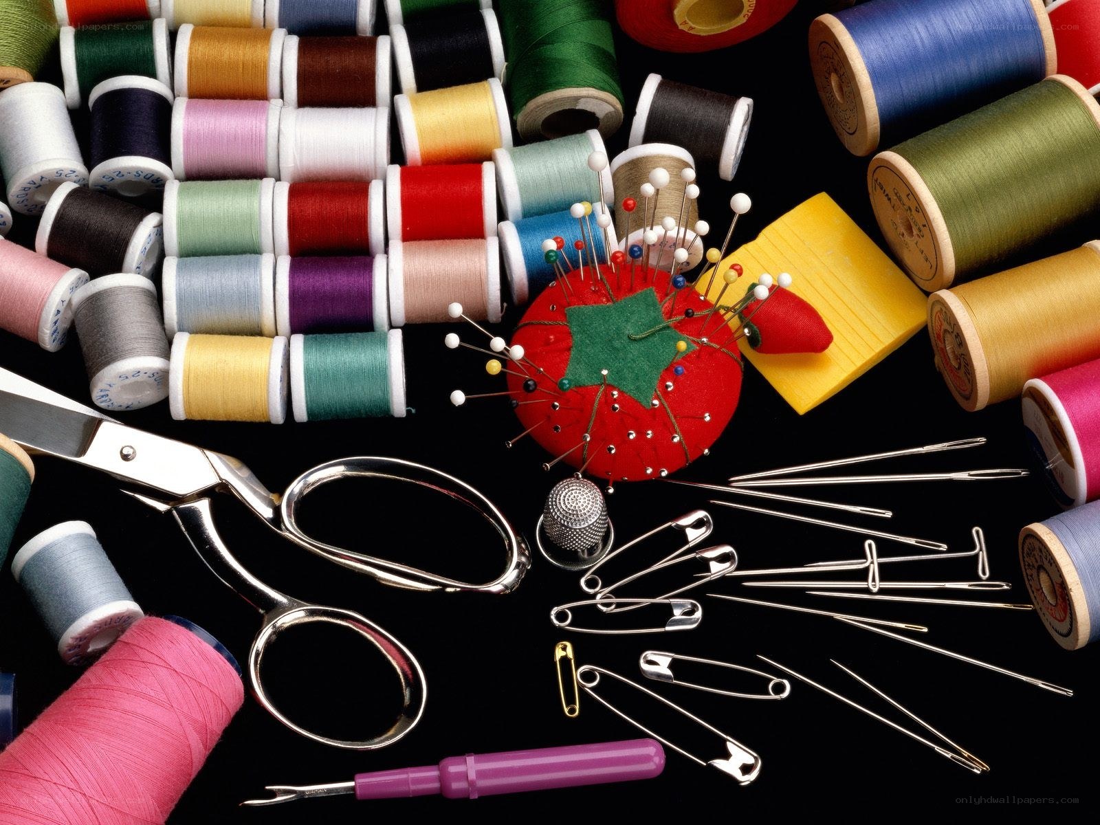 Sewing supplies on black background