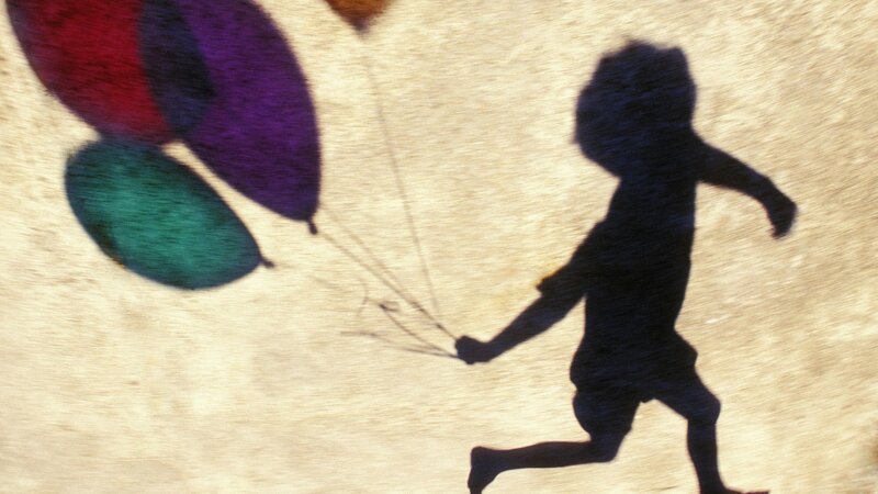 Shadow of child with balloons