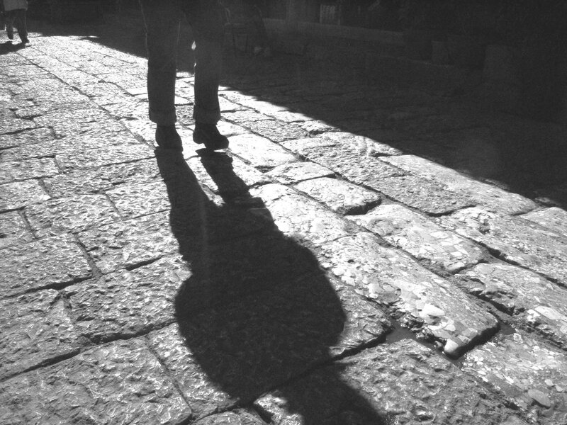shadow on cobblestone street