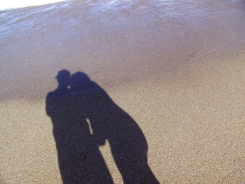 Shadows of a couple on the beach