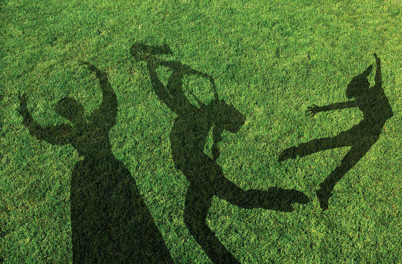Shadows of dancers on grass