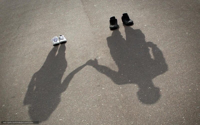 Shadows of two people holding hands